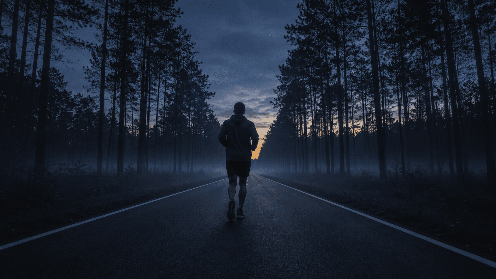 Person running on a trail at sunrise — representing consistent habit execution and pushing through the plateau phase of behavior change